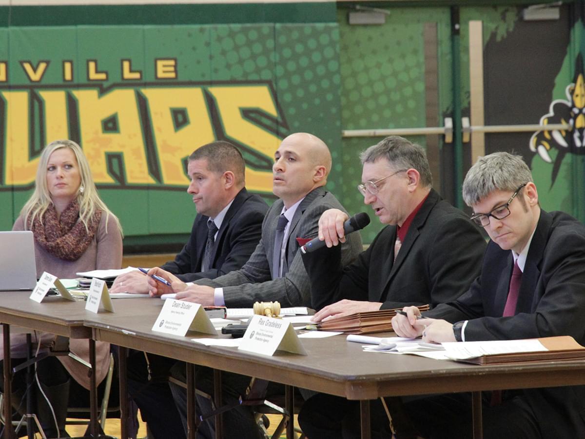 Hearing officer Dean Studer speaking into a microphone