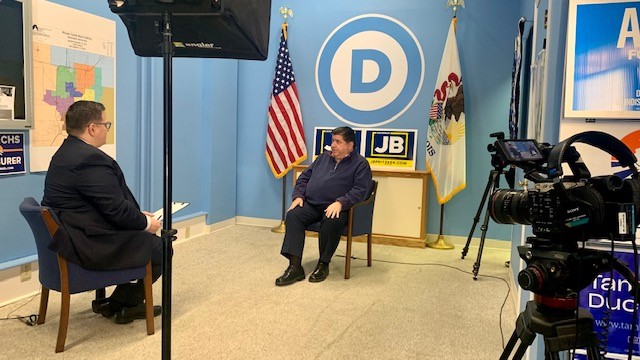 Brian Mackey, host of The 21st show, talks to Gov. JB Pritzker (D-IL) in Bloomington.