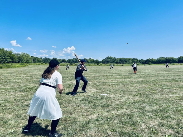 A player up for bat as the pitcher is getting ready to throw ball. 