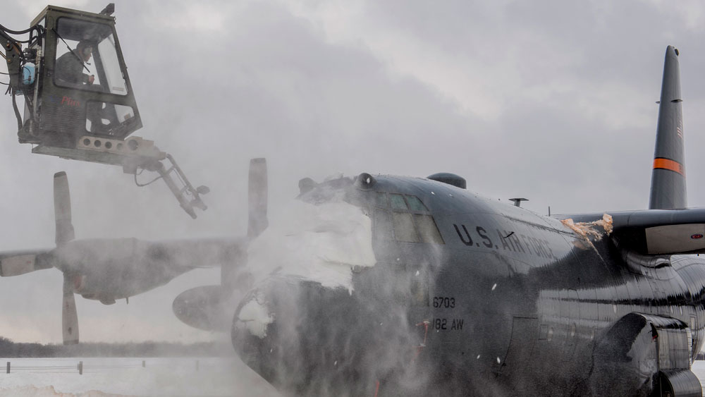 U.S. Air Force Tech. Sgt. Andrew Smith, an aerospace maintenance specialist with the 182nd Aircraft Maintenance Squadron, Illinois Air National Guard, de-ices a C-130H3 Hercules on the flight line at the 182nd Airlift Wing in Peoria, Illinois, Jan. 13, 2019. 