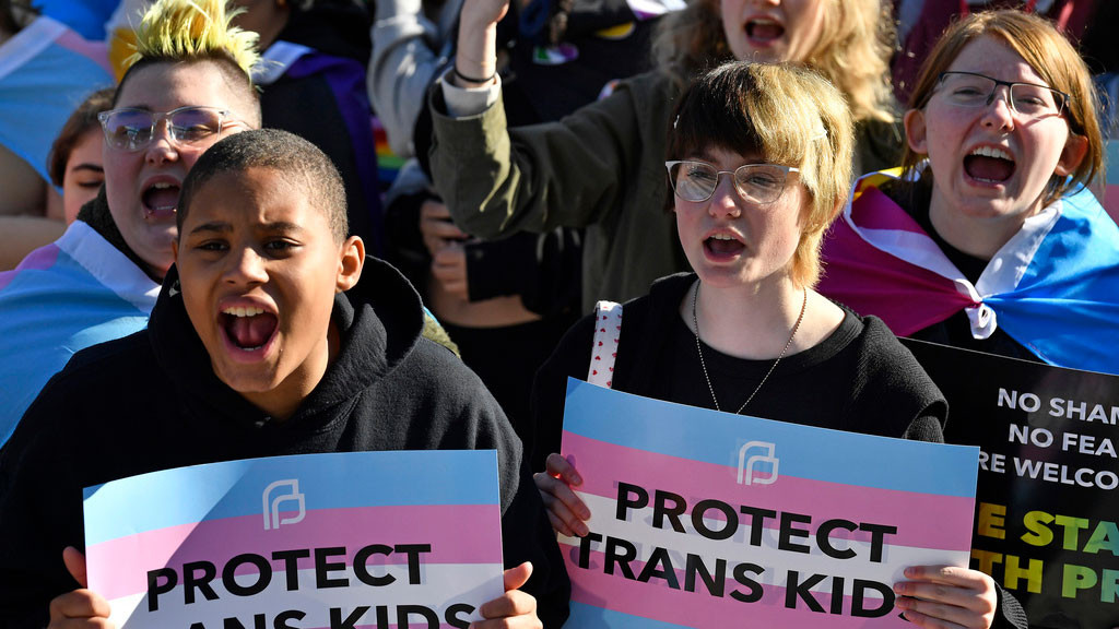 Protesters of Kentucky Senate bill SB150, known as the Transgender Health Bill, cheer on speakers during a rally on the lawn of the Kentucky Capitol in Frankfort, Ky., March 29, 2023. Several families on Wednesday, May 3, 2023, challenged Kentucky's ban on gender-affirming care for transgender youths, claiming the prohibition interferes with parental rights to seek established medical treatment for their children.