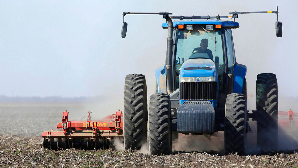 In this April 4, 2013 file photo a central Illinois corn and soybean farmer cultivates his field for spring planting in Waverly, Ill.