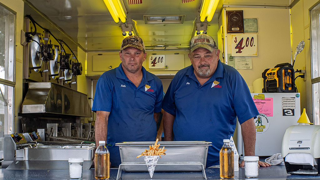 two men stand in fry trailer