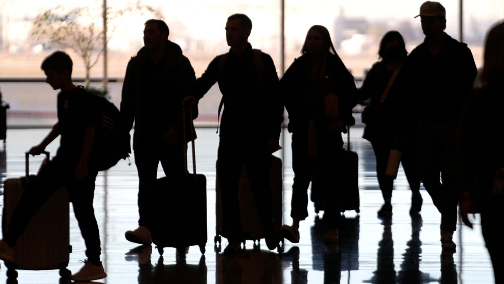 People pass through Salt Lake City International Airport Wednesday, Jan. 11, 2023, in Salt Lake City. The world's largest aircraft fleet was grounded for hours by a cascading outage in a government system that delayed or canceled thousands of flights across the U.S.