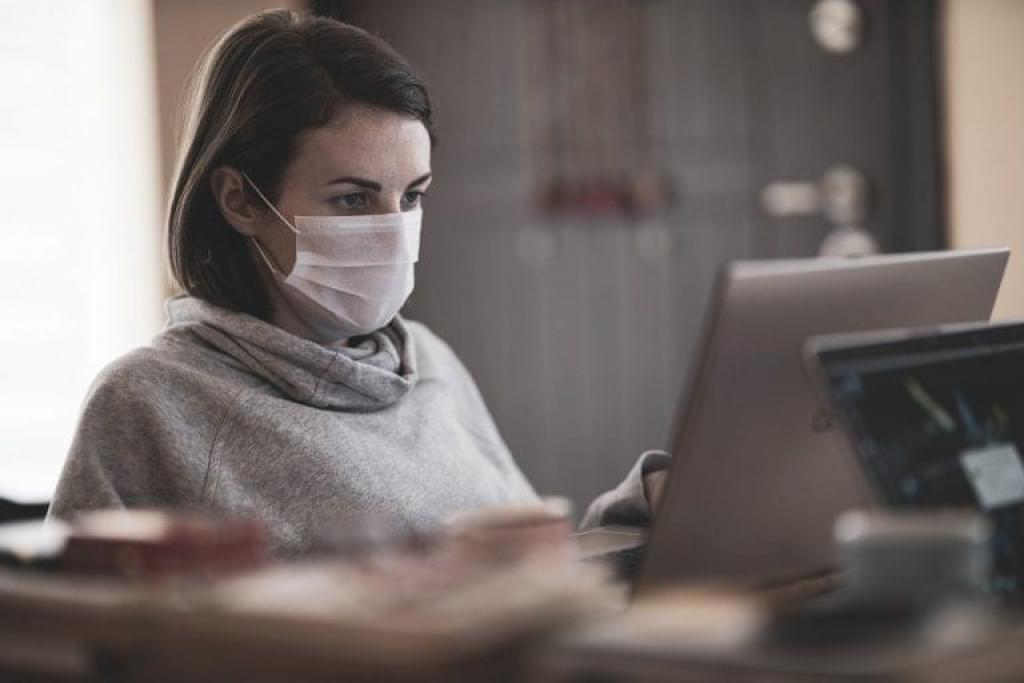 Woman works while masking.