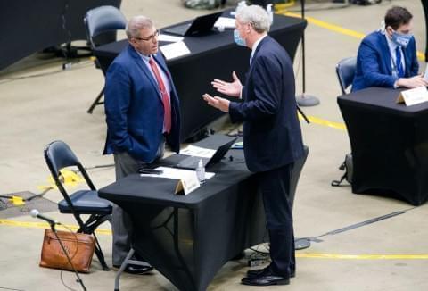 Illinois state Rep. Darren Bailey, R-Louisville, left, listens to Illinois House Minority Leader Jim Durkin, R-Western Springs, as they speak before the Illinois House of Representatives voted 81-27 to remove Bailey from the House floor for not wearing a mask on Wednesday, May 20, 2020. A dozen Republicans joined Democrats in voting for his removal. The House is meeting at the Bank of Springfield Center instead of the Capitol to afford more space for social distancing amid the COVID-19 pandemic.