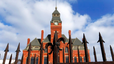 Part of the 1910 iron fence stands in front of the Pullman Clock Tower and Administration building in the Pullman neighborhood of Chicago. Supporters of the revitalization of Chicago's historic Pullman neighborhood say they have the money for more restoration work, five years after then-President Barack Obama designated part of the area as a national monument. A central part of the restoration is the Pullman Clock Tower and Administration building, which will convert into a visitors center. 