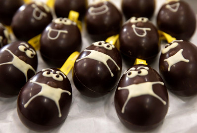 A tray of chocolate eggs with protective face masks are laid out on a tray at the Chocolate Line warehouse of Dominique Persoone in Bruges, Belgium. 