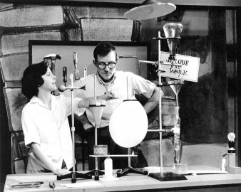 Man and child stand behind a chemistry set