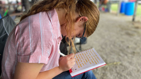 girl sitting and writing in journal