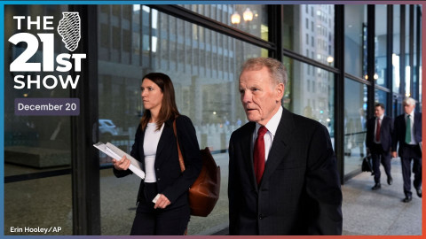 Michael Madigan, dressed in a dark suit, white shirt and red necktie, walks with an unidentified woman in business attire past the glass walls of the courthouse lobby